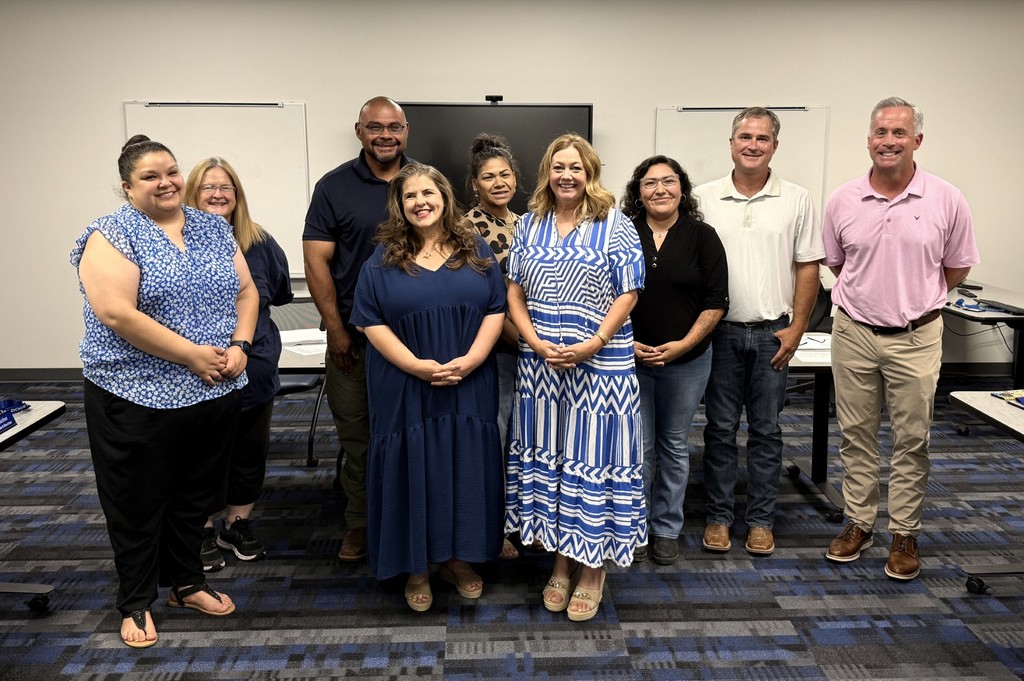 School board members and teachers getting recognized for TIA designations.