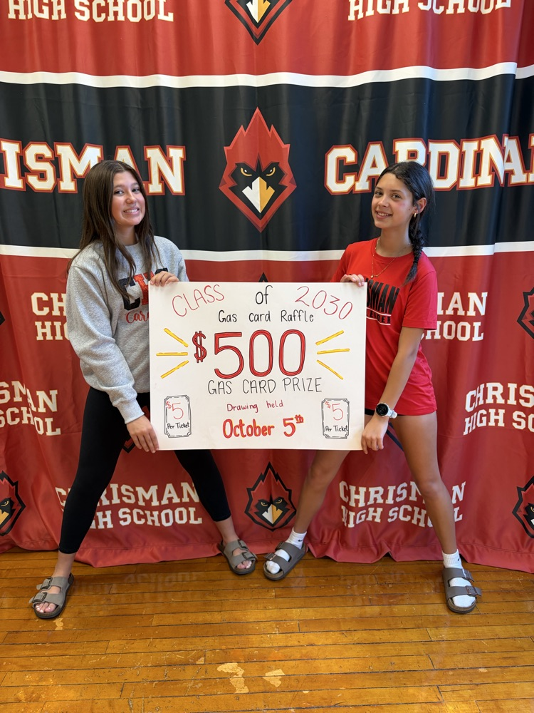 Freshmen Claire and Willa hold  raffle ticket signs