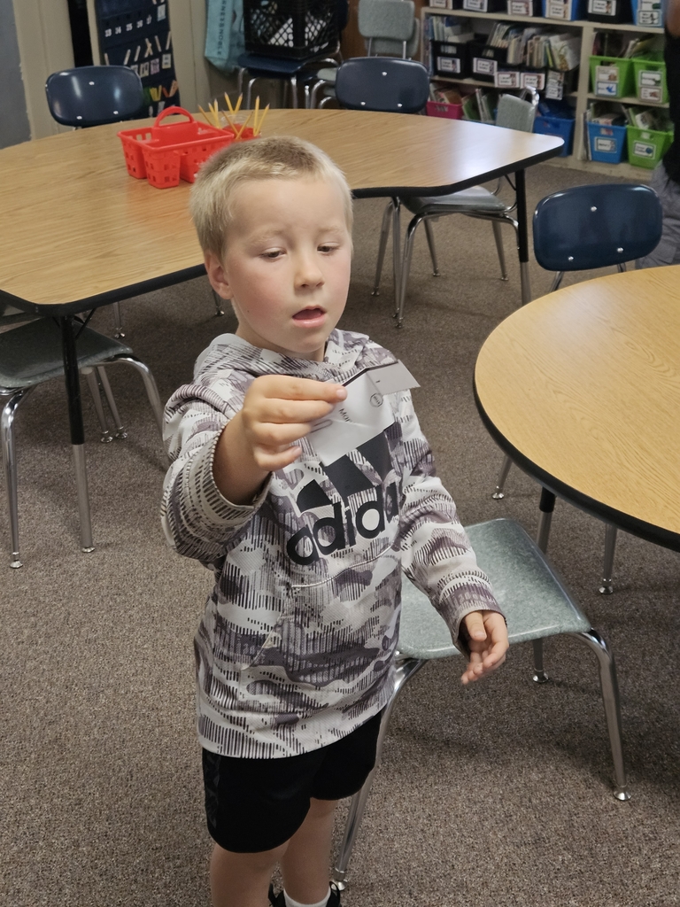 a boy dropping paper seeds