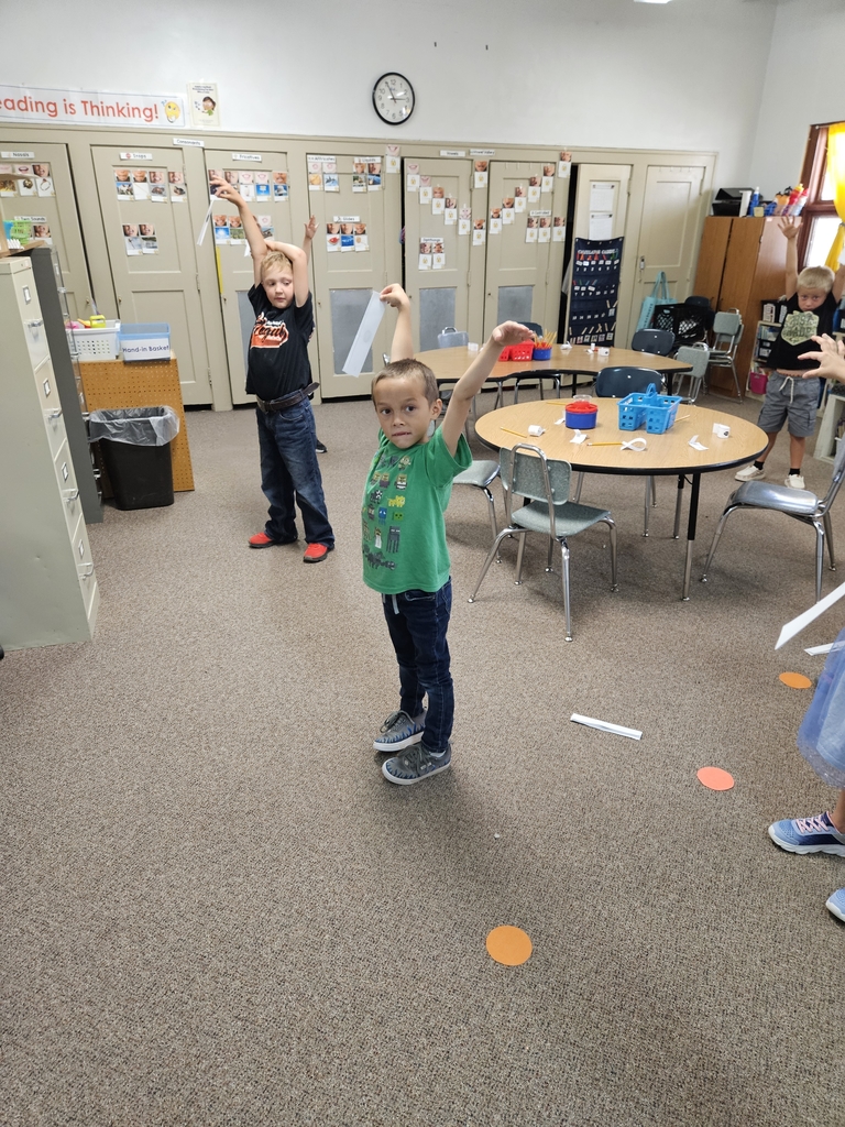 2 boys dropping paper seeds