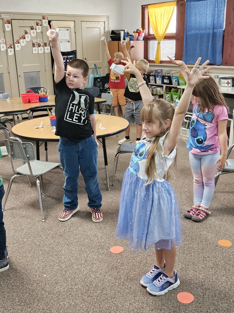 5 kids dropping paper seeds
