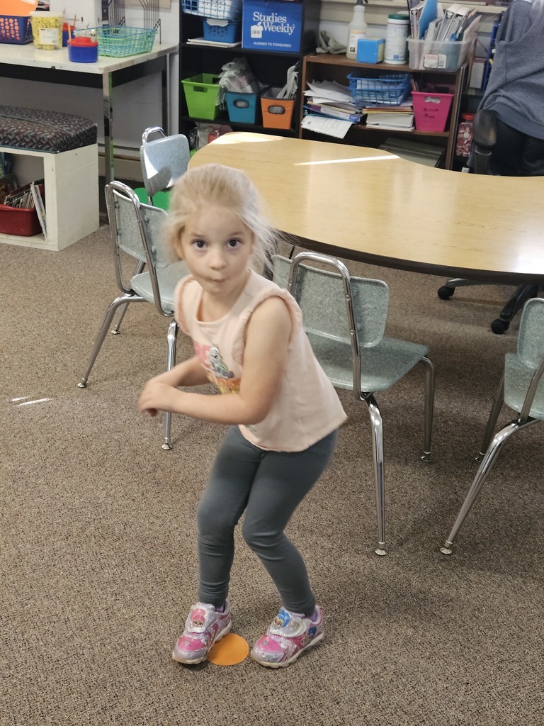 a girl making the letter s with her body