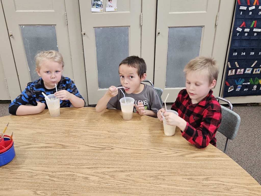 3 kids drinking root beer floats