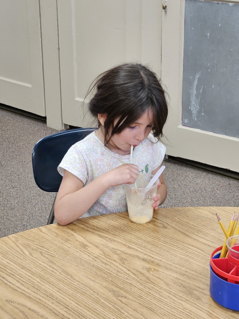 a girl drinking a root beer float