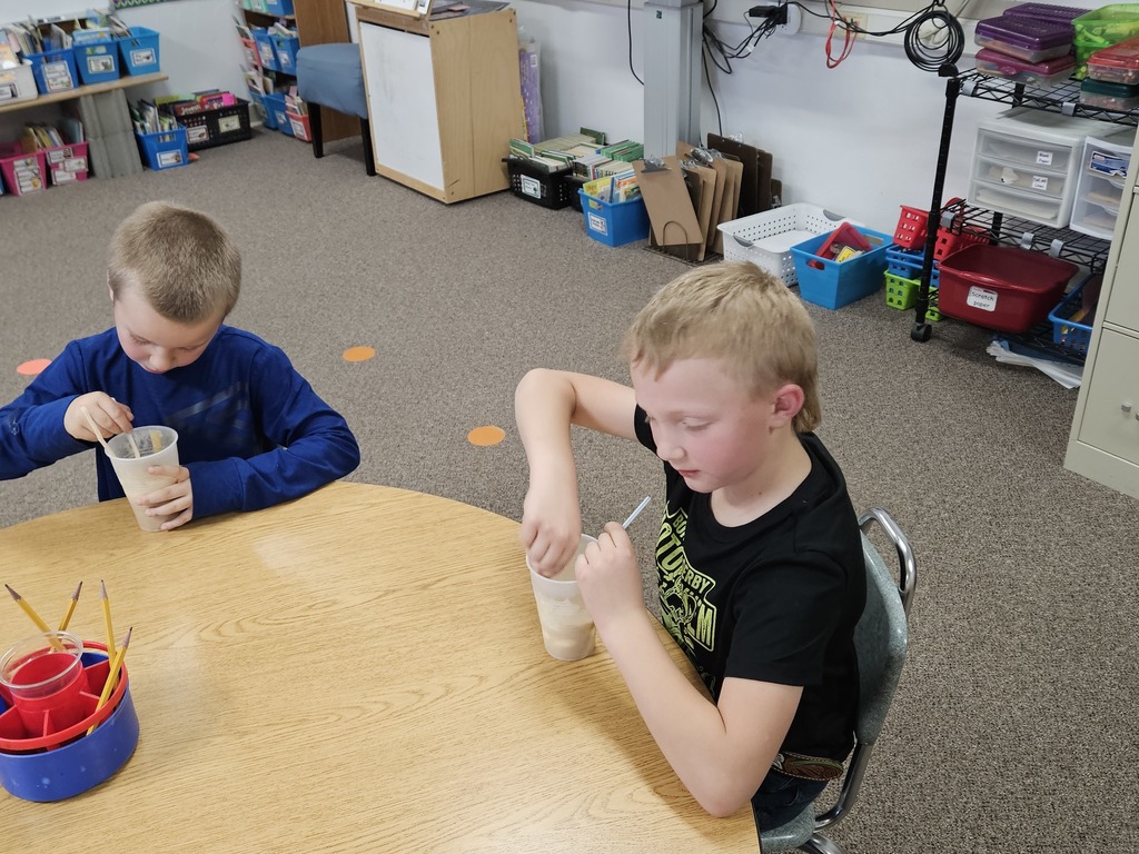 2 boys drinking root beer floats