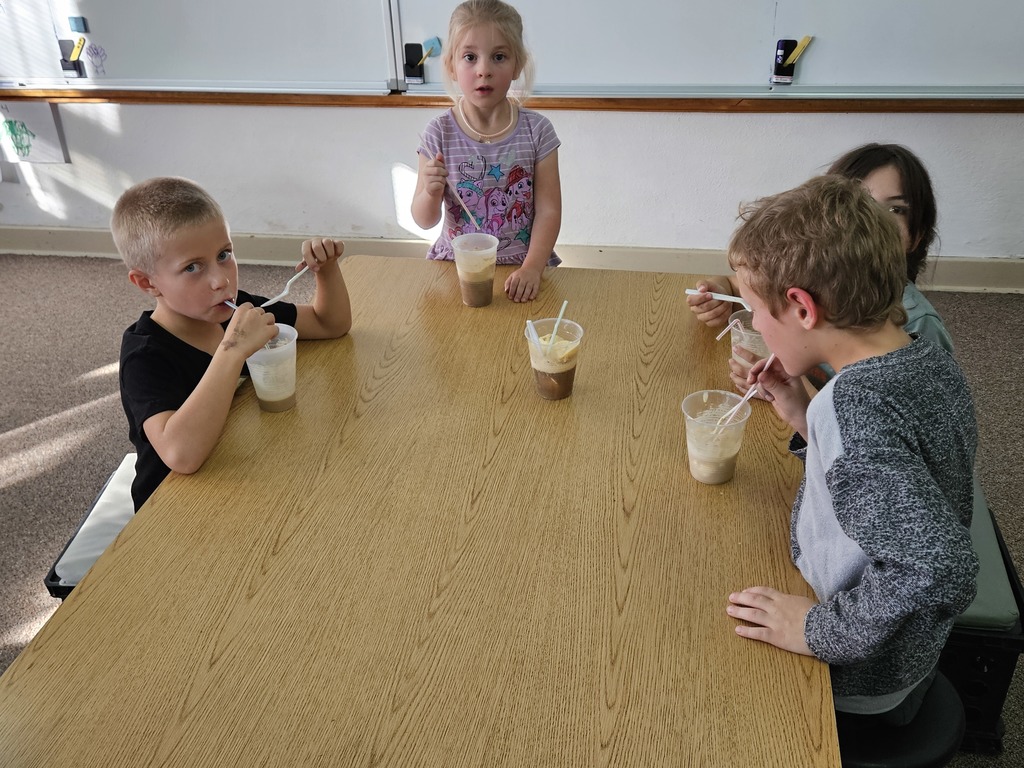 4 kids drinking root beer floats