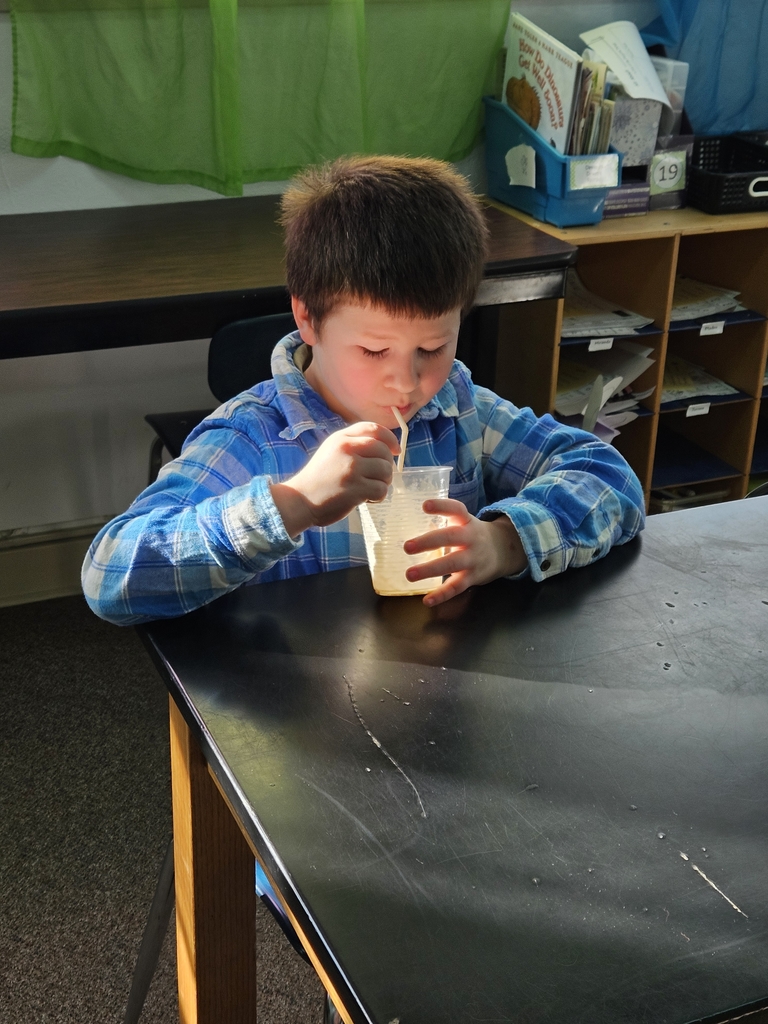 a boy drinking a root beer float