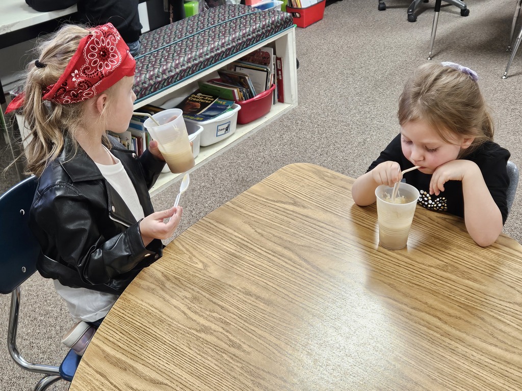 2 girls drinking root beer floats