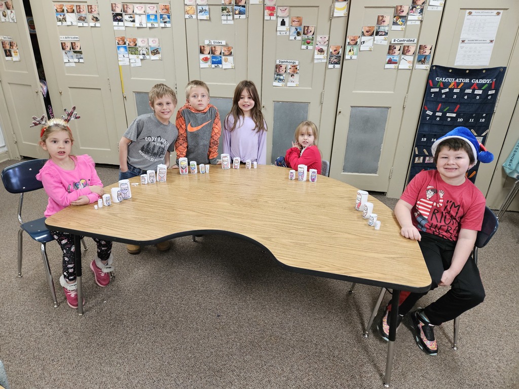 6 kids with paper Santa's