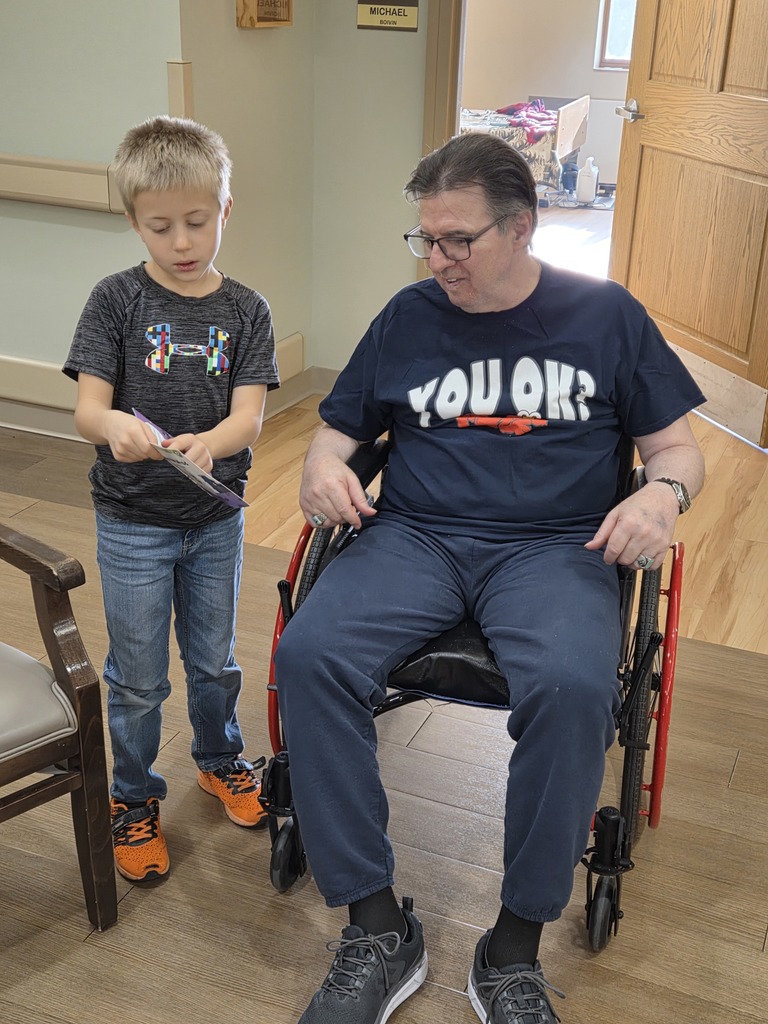 a boy reading to a man