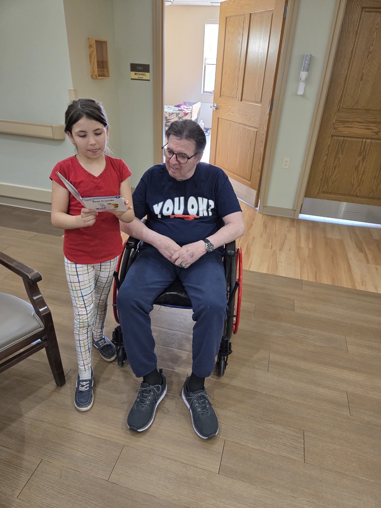 a girl reading to a man