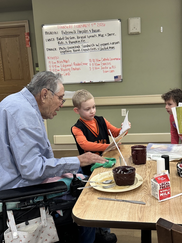 a boy reading to a man