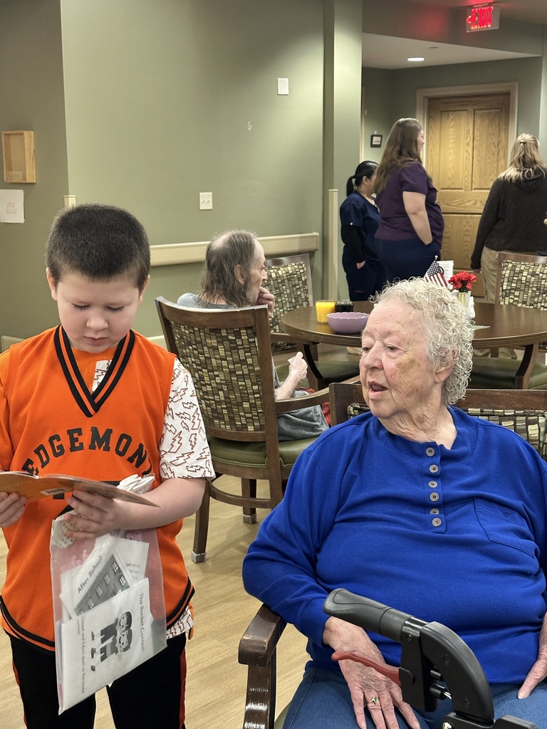 a boy reading to a lady