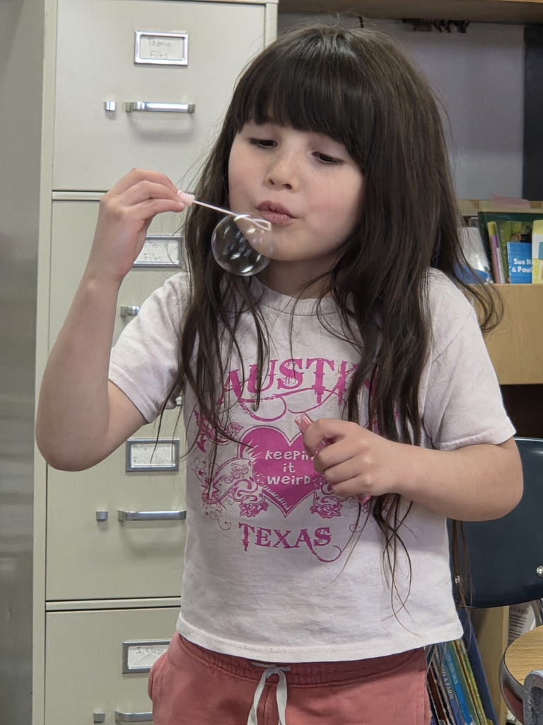 A girl blowing bubbles 