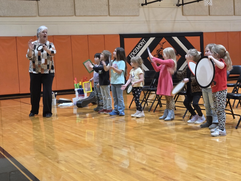 8 kids and 1 teacher playing drums