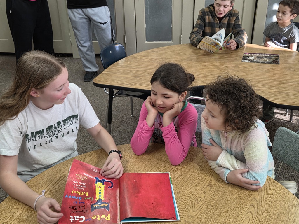 2 little girls and 1 middle school girl reading