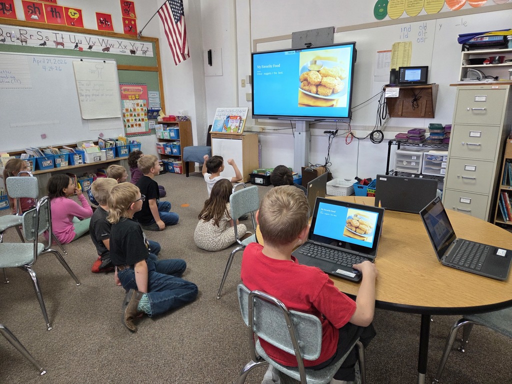10 kids looking at a big screen