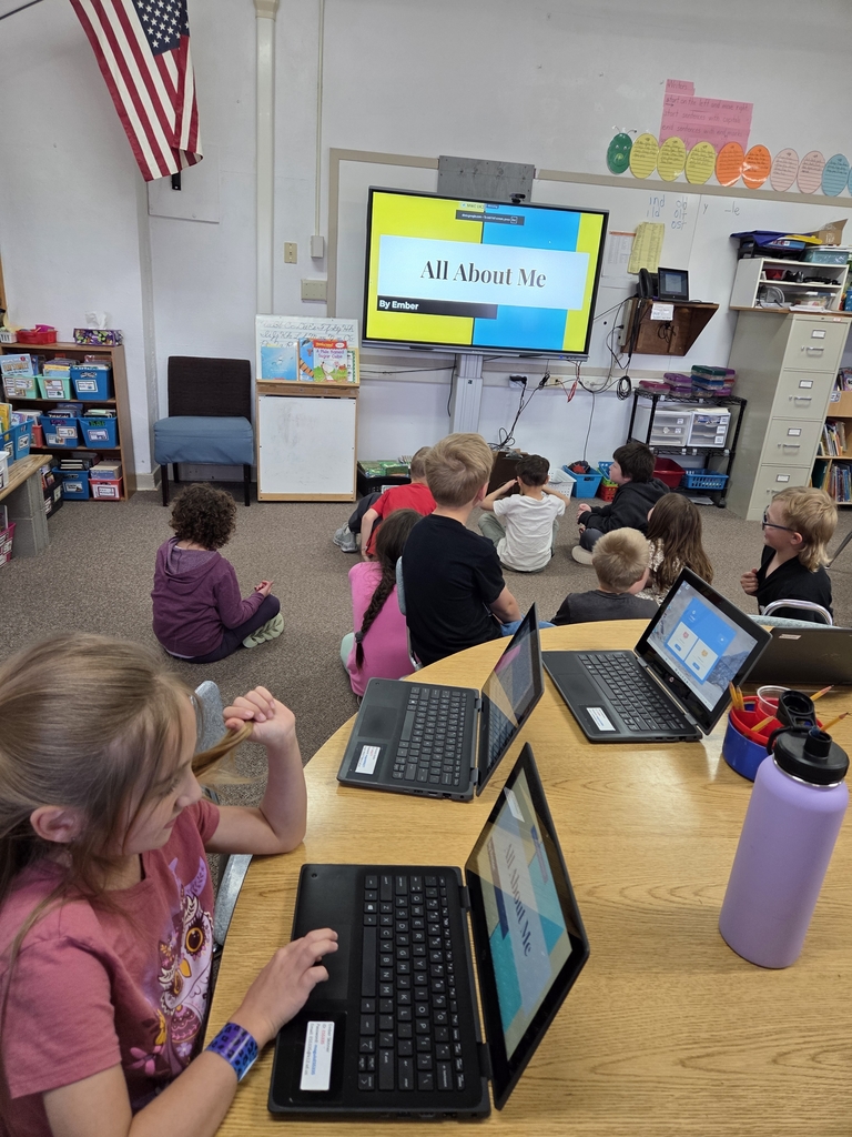 10 kids looking at a big screen