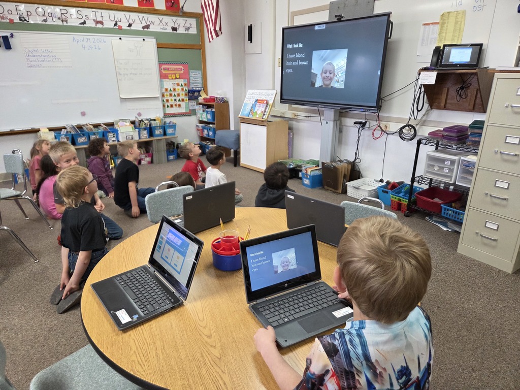 10 kids looking at a big screen