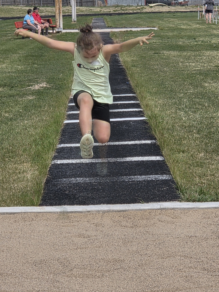 a girl jumping into the sand