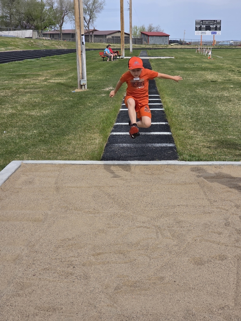 a boy jumping into the sand