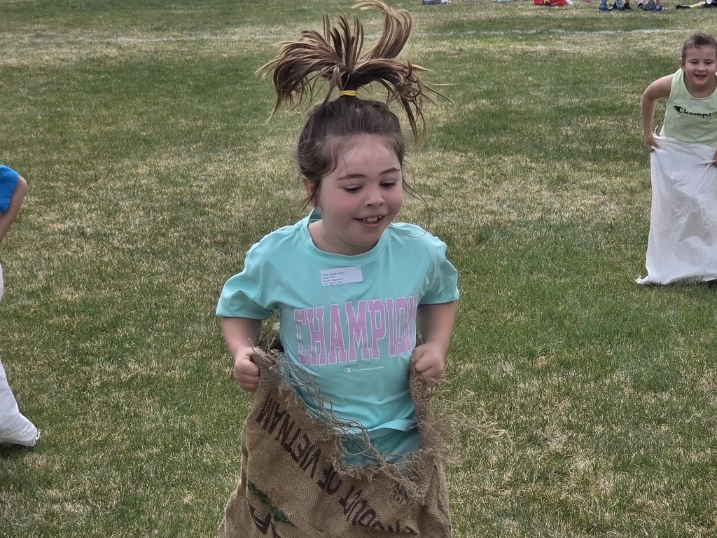 a girl hopping in a potato sack 