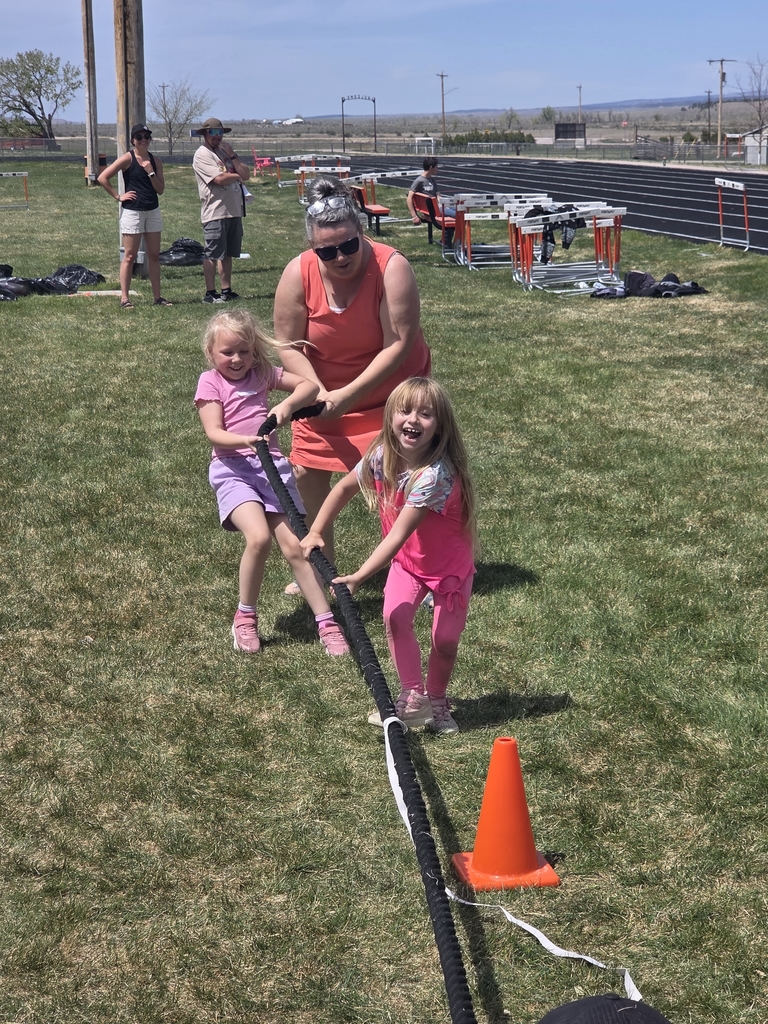 2 girls and a teacher tugging on a rope 