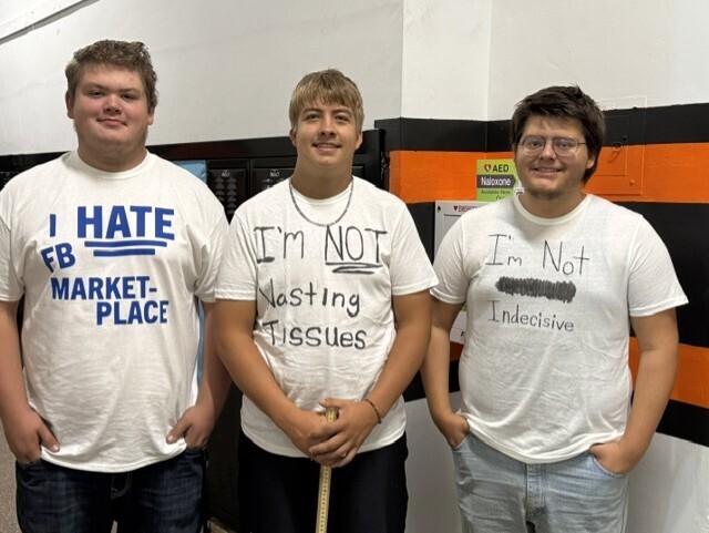 three young men wearing white t-shirts with statements written on them