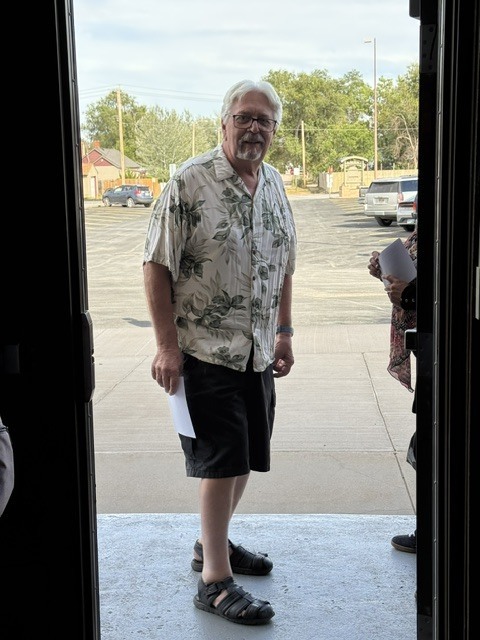 teacher in doorway wearing Hawaiian shirt