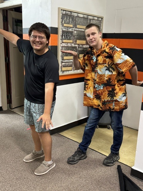 senior boys in Hawaiian shirts and surfing poses