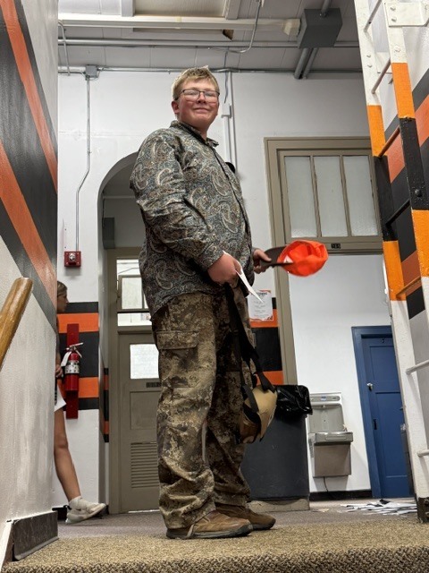 student dressed in camouflage hunting attire