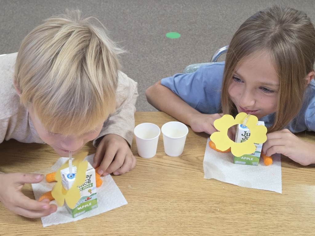 a boy and a girl drinking juice