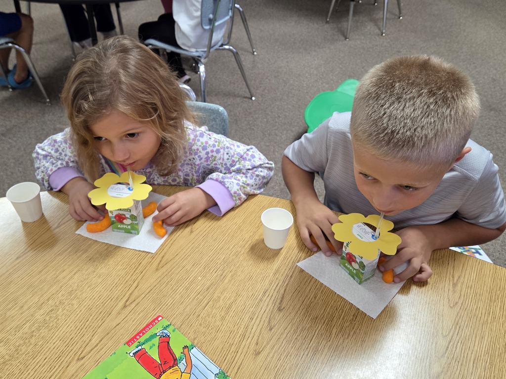 a girl and a boy drinking juice