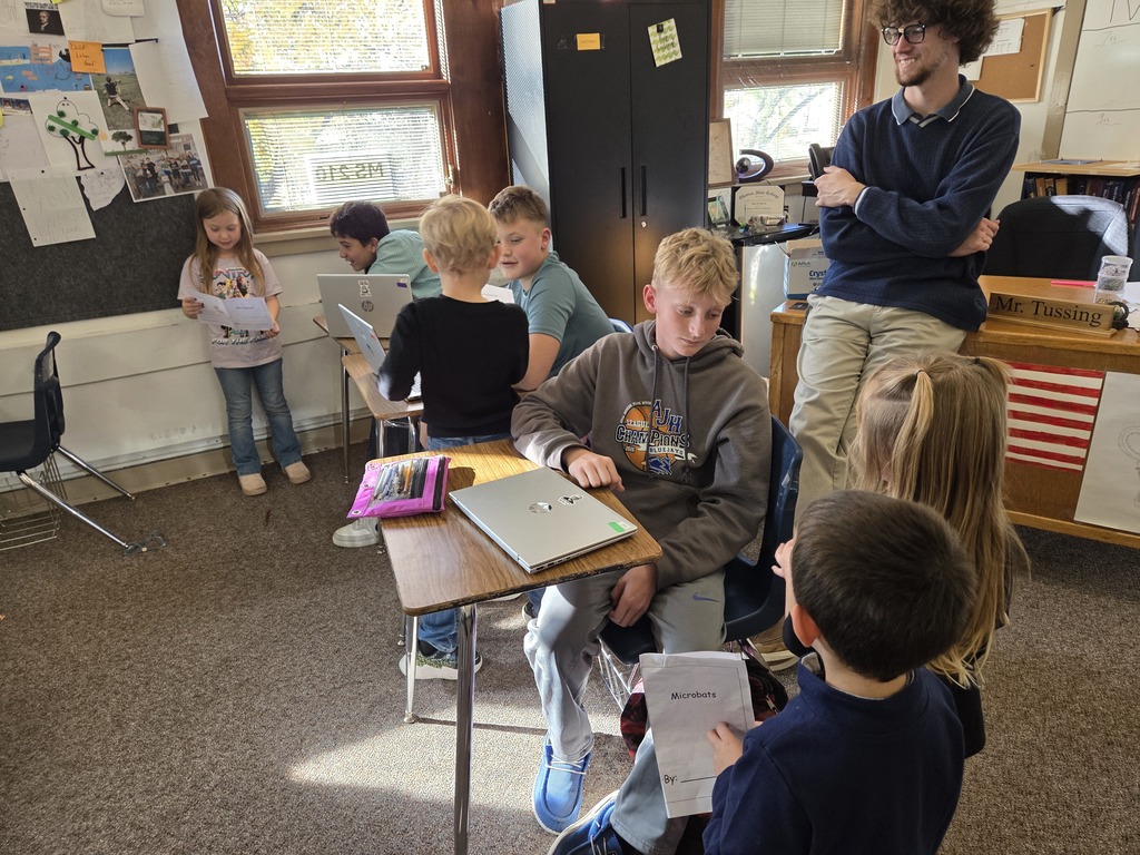 7 kids and a teacher reading together