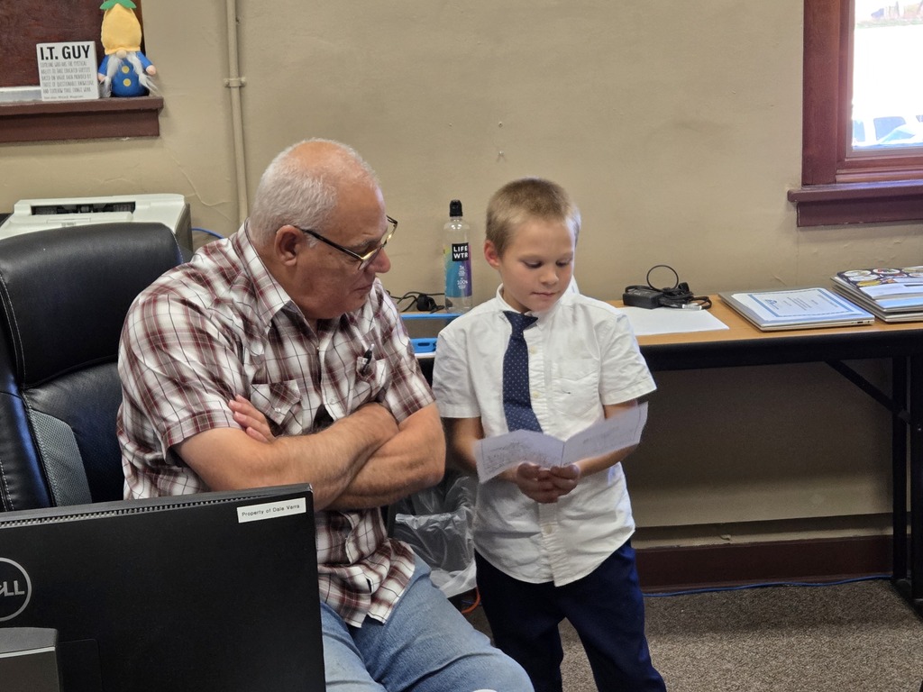 a kid and a teacher reading together