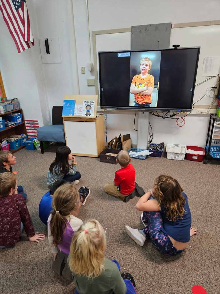 Eight students watching a screen