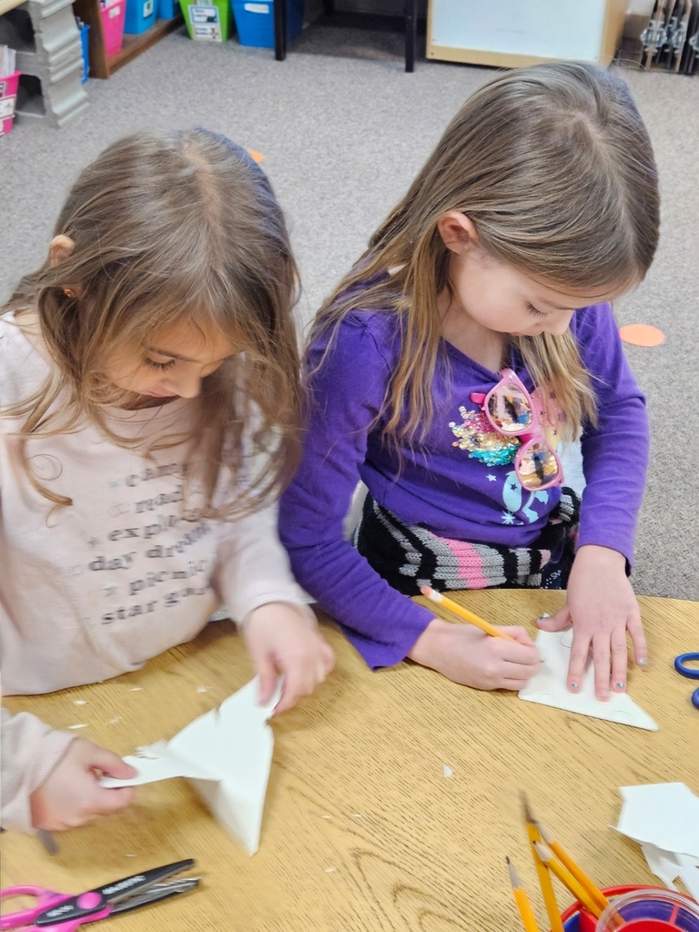 2 girls folding paper