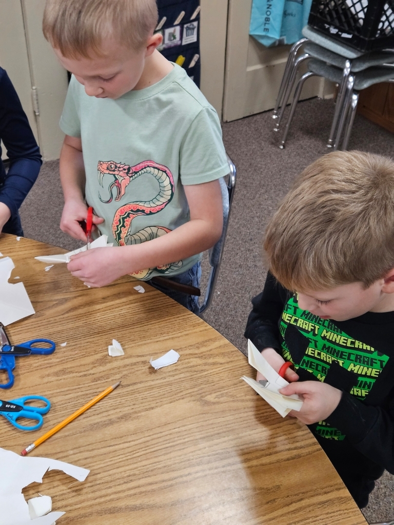 2 boys cutting paper