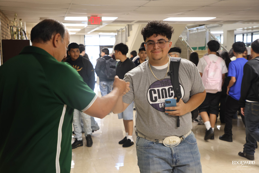Coach O gives a student a fist bump on the first day at JFK