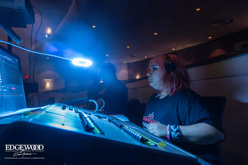 Photo of a studen running the sound and light boards for Hadestown