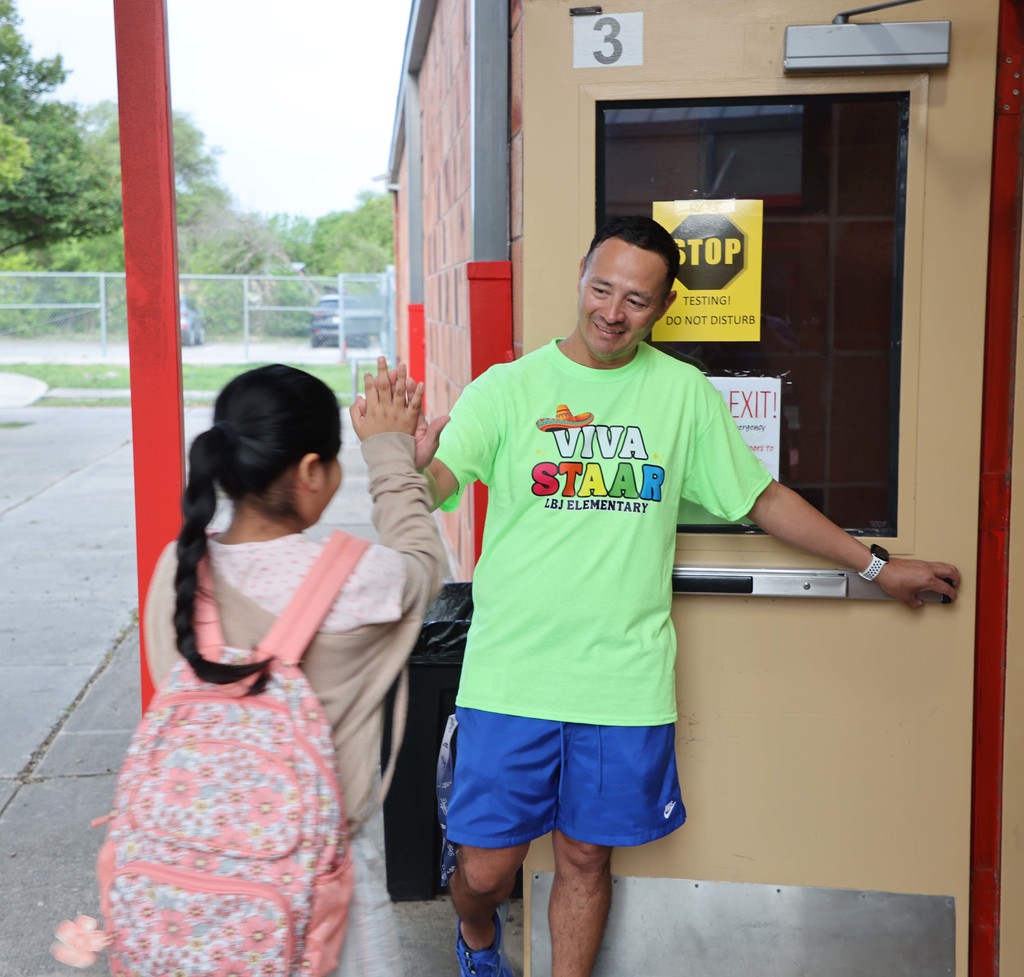 teacher gives student a high-five on STAAR testing day