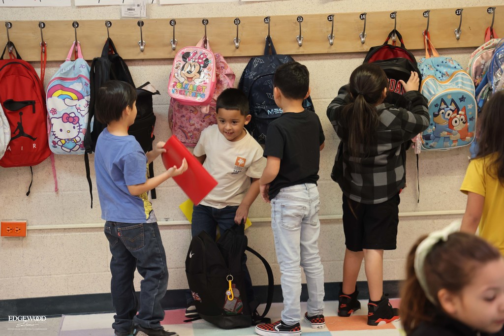 students hang their backpacks