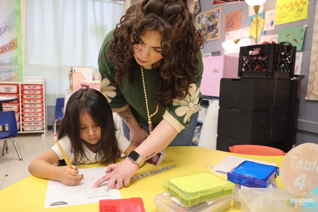 LBJ teacher helps student write the letter P