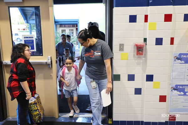 Teacher walking student into school
