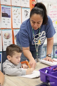 Teacher and student working on classwork together
