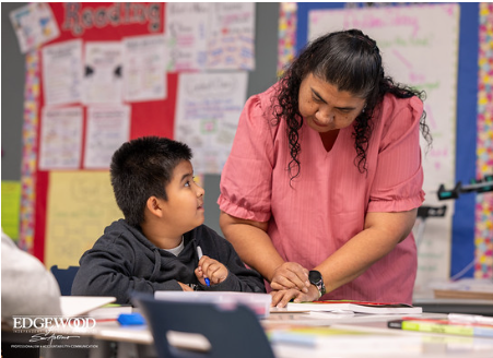 Teacher helping student with classwork