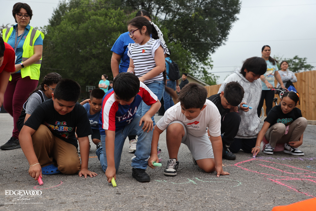 Students drawing with chalk working together
