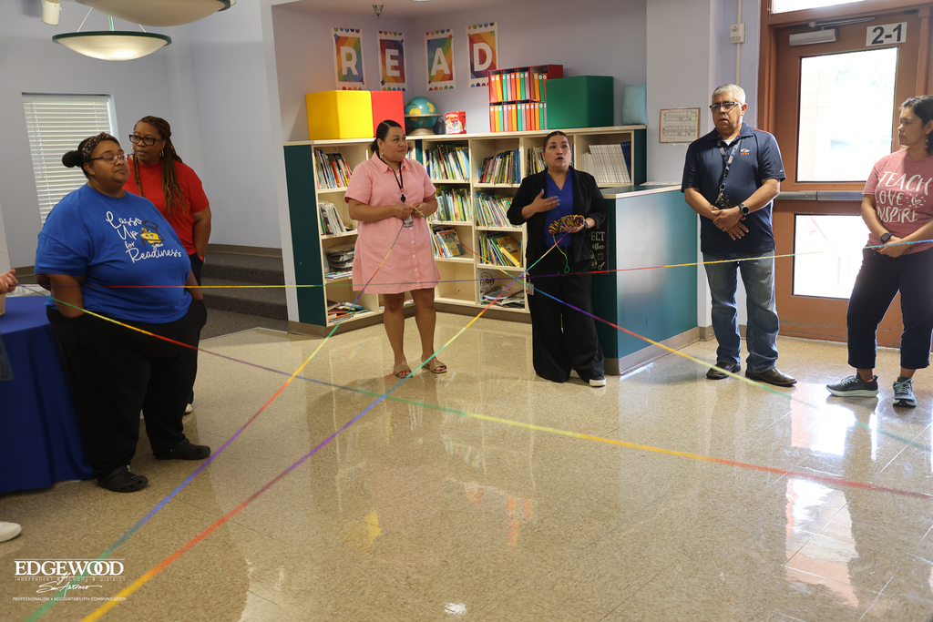Stafford ECC staff do a team bonding exercise by tossing yarn to build a "web" of support for teachers
