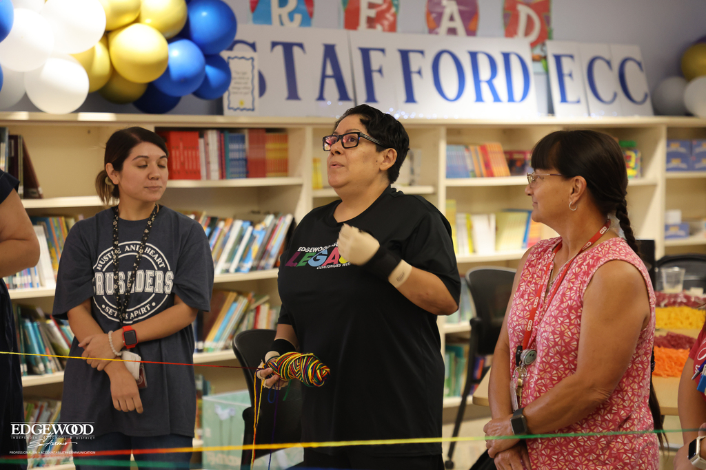 Stafford ECC staff do a team bonding exercise by tossing yarn to build a "web" of support for teachers