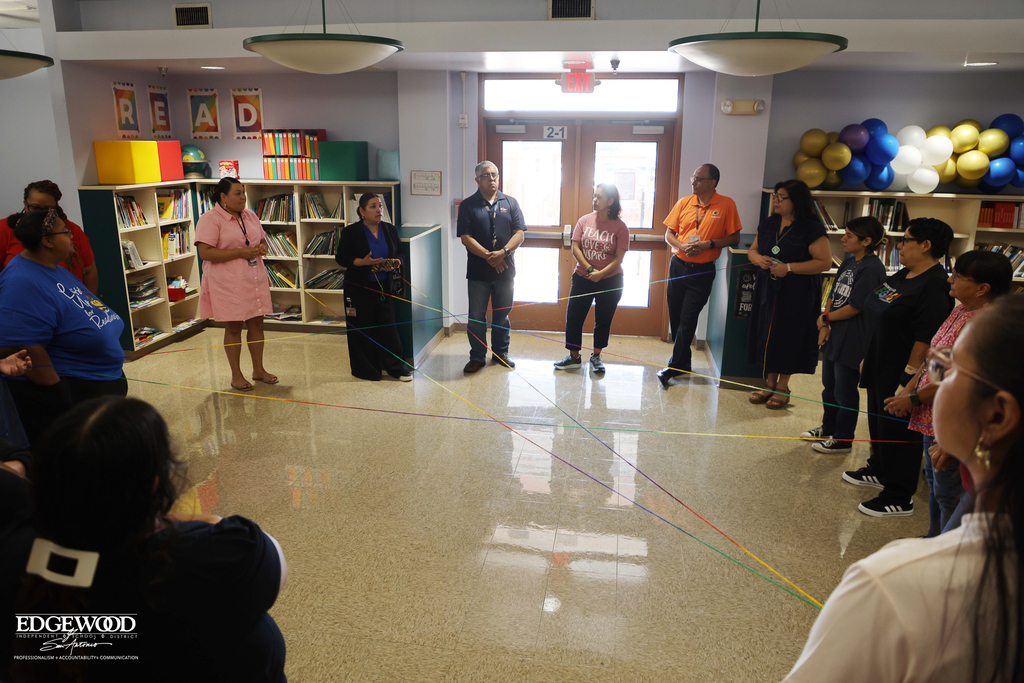 Stafford ECC staff do a team bonding exercise by tossing yarn to build a "web" of support for teachers